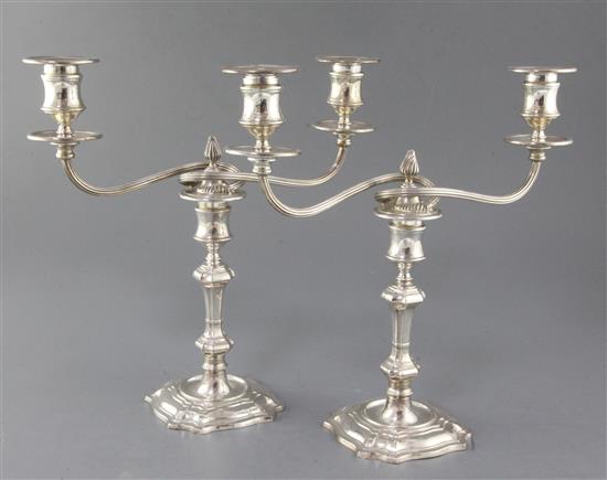 A pair of late 1960s silver two branch, two light candelabra by James Dixon & Sons, weighted.